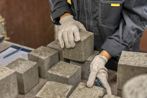 Worker Checking Quality Of Concrete Blocks | UltraTech Cement