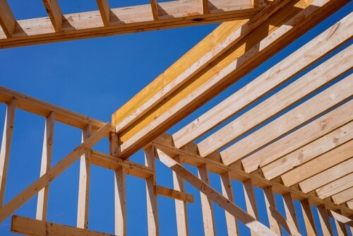 Using wooden beams sticks as framework for construction of new home