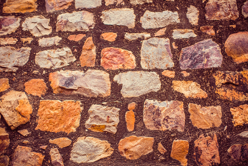 ancient stone wall. New Delhi: Qutub (Qutb) Minar