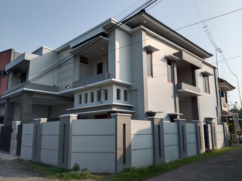 Modern two-story grey house behind a fenced wall | Ultratech