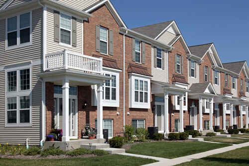 Row of brick townhouses with covered entries
