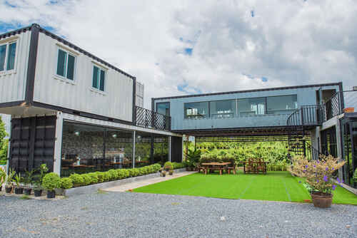 Modern metal building made from shipping containers and blue sky background .