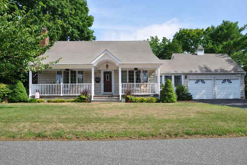 Suburban Bungalow Style Home with Attached Garage Residential neighborhood usa blue sky clouds