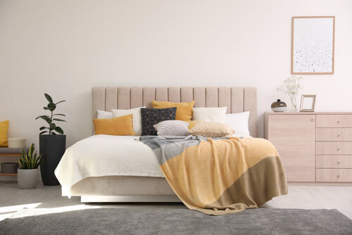 Stylish interior of contemporary room with comfortable bed