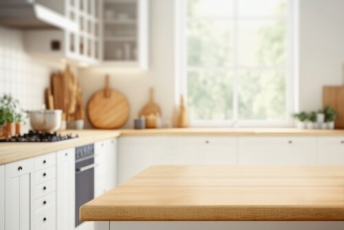 Wood table top on blurred kitchen background.  can be used mock up for montage products display or design layout
	