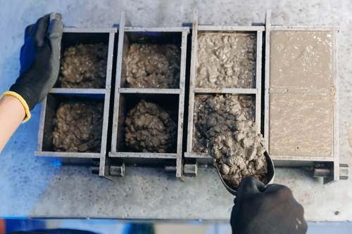 Worker testing concrete by putting in cubes | UltraTech Cement