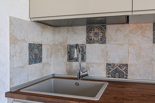 Kitchen sink with a tap and tiled wall | Ultratech
