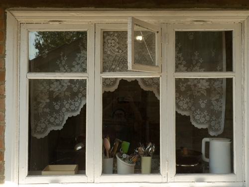 A white window with lace curtains | Ultratech