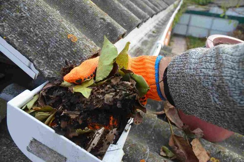 Worker Cleaning The Roof Water Drainage System | UltraTech Cement