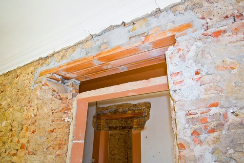 New reinforced brick lintel useful for creating a new door, or a new window, in an old stone and brick wall in a construction site