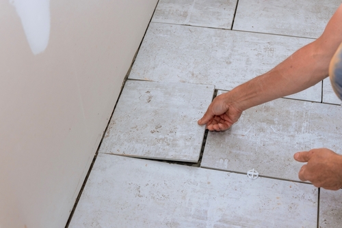 Tiling tools on shelf against a blue tile wall | Ultratech