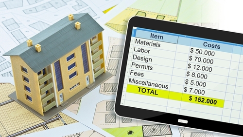 Model house with a renovation cost estimate displayed on a calculator screen