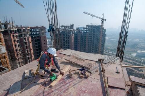 Noida, Uttar Pradesh, India-Dec 21 2019: Concrete work Builder carpenter worker preparing construction formwork for concreting at building area,  building construction work 