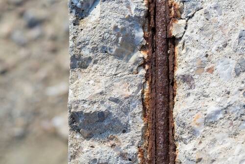 Old reinforced concrete structure with damaged and rusty metallic reinforcement that must be demolished - Metal bars rusty due to water infiltration into concrete 