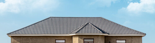 The roof of the house of the metal profile against the sky