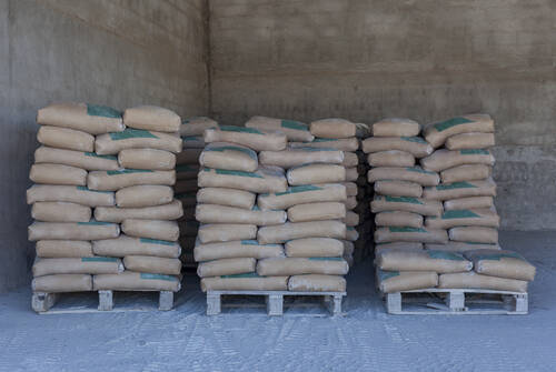 Cement bag Placed neatly in the storage room,Waiting for distribution,Wait for construction