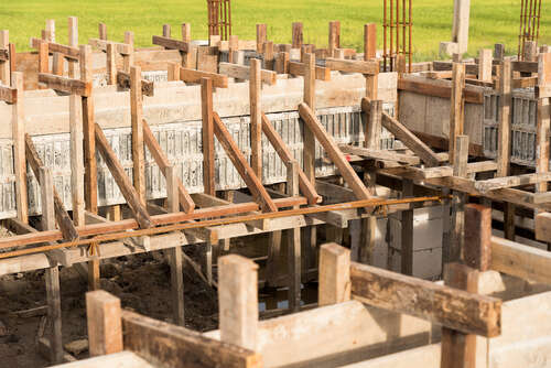 Wooden form work concrete foundation of building on construction site.