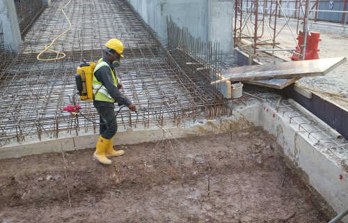 KUALA LUMPUR, MALAYSIA -JUNE 29, 2017: Construction workers spraying the anti termite chemical treatment to the soil at the construction site. 