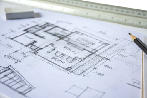 plan and elevation of home preliminary design sketch by black pencil on white paper and white background with drawing tools, scale rulers, rubber, selective focus