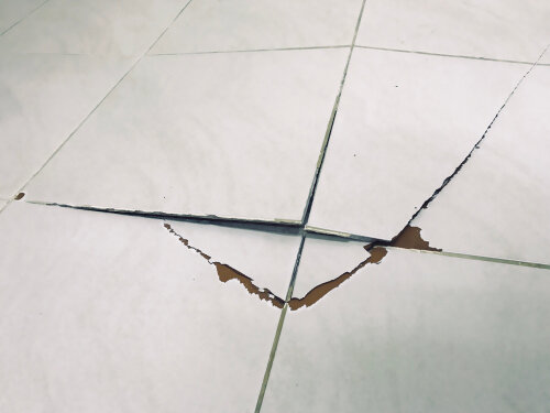 Tile floor exploded and cracked because used for a long time