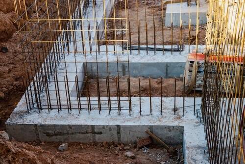 Monolithic foundation with metal reinforcement. Forms vertical formwork structures for the basement of a residential building. Monolithic concrete foundation. Support foundation. Home construction