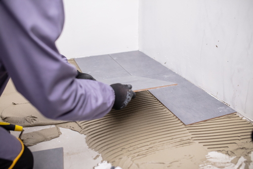 Worker install tiles on bathroom