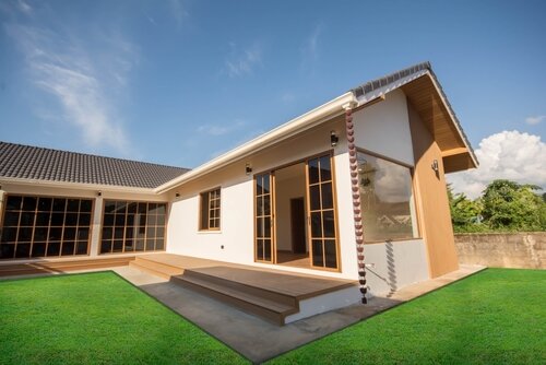 One-story house, L shape, white and brown.